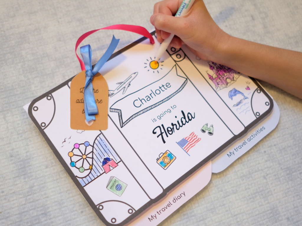 Child writing in Disney World travel journal during Magic Kingdom trip